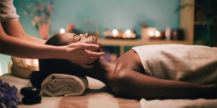 black woman getting relaxing spring massage in spa